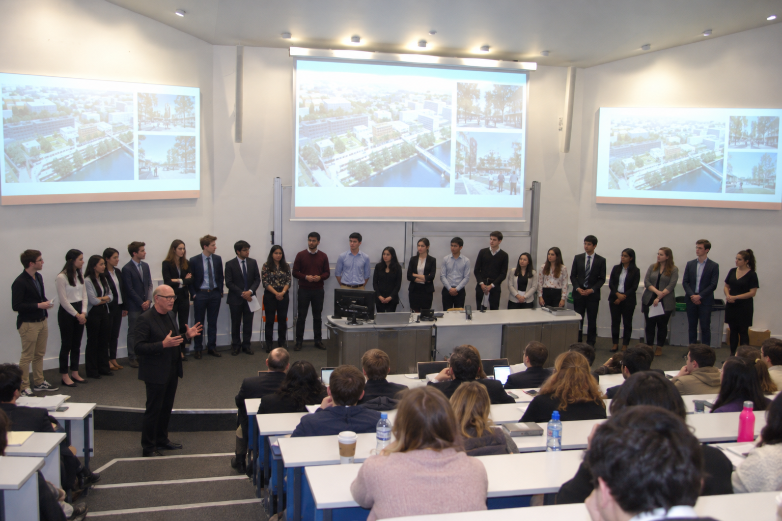 Students presenting to an audience with a speaker at the front